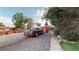 Gravel backyard with parked car and a storage container, near a tree with ripe apples at 103 S Zenobia St, Denver, CO 80219