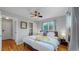 Cozy bedroom featuring hardwood floors, ceiling fan and large window offering natural light at 103 S Zenobia St, Denver, CO 80219