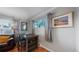 Cozy dining area with hardwood floors, neutral paint, and a large window for plenty of natural light at 103 S Zenobia St, Denver, CO 80219
