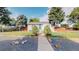 Charming home with a walkway to the entry surrounded by rock landscaping and established trees at 103 S Zenobia St, Denver, CO 80219