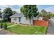 Charming home featuring a well-maintained lawn, mature trees, and a light blue front door at 103 S Zenobia St, Denver, CO 80219