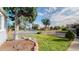 Well-maintained front lawn with a decorative rock border and mature trees adding character at 103 S Zenobia St, Denver, CO 80219