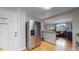 Stainless steel fridge in a well-lit kitchen with hardwood floors, adjacent to the living area at 103 S Zenobia St, Denver, CO 80219