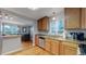 Kitchen with stainless steel appliances and granite countertops open to dining and living areas at 103 S Zenobia St, Denver, CO 80219