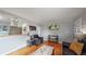 Comfortable living room featuring hardwood floors, neutral paint, with a seamless flow to the kitchen and dining area at 103 S Zenobia St, Denver, CO 80219