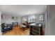Open living space featuring hardwood floors, a dining area, and a comfortable seating area at 103 S Zenobia St, Denver, CO 80219