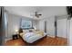 Comfortable bedroom featuring hardwood floors, a ceiling fan, and ample closet space at 103 S Zenobia St, Denver, CO 80219