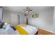 Bright bedroom with hardwood floors, television, and closet storage at 103 S Zenobia St, Denver, CO 80219