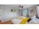 Sunlit bedroom with hardwood floors, TV, and comfortable decor at 103 S Zenobia St, Denver, CO 80219