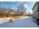 Large backyard enclosed by a wooden fence with a retaining wall at 5481 E 117Th Ave, Thornton, CO 80233