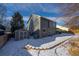 Exterior view of home featuring a shed, patio area, and snow covered backyard at 5481 E 117Th Ave, Thornton, CO 80233