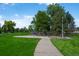 Outdoor basketball court surrounded by lush greenery and a walking path at 5481 E 117Th Ave, Thornton, CO 80233