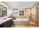 Stylish bathroom boasting a glass shower and soaking tub with decorative tile at 5481 E 117Th Ave, Thornton, CO 80233