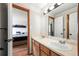 Clean bathroom showcasing double sinks and a view into the adjacent bedroom at 5481 E 117Th Ave, Thornton, CO 80233