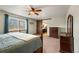 Serene bedroom featuring a wooden frame bed, natural light, and a rustic barn door at 5481 E 117Th Ave, Thornton, CO 80233