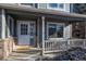 Close up of a cozy front porch with seating and 'welcome' mat, offering curb appeal at 5481 E 117Th Ave, Thornton, CO 80233