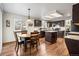 Charming kitchen featuring dark cabinetry, an island, and a cozy breakfast nook at 5481 E 117Th Ave, Thornton, CO 80233