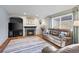 Comfortable living room featuring a fireplace, plush leather seating, and natural light from the window at 5481 E 117Th Ave, Thornton, CO 80233