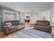 Open-concept living room with hardwood floors and a view of the kitchen at 5481 E 117Th Ave, Thornton, CO 80233