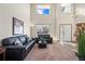 Bright living room with soaring ceilings, staircase, and ample natural light from large windows at 5481 E 117Th Ave, Thornton, CO 80233