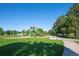 Community playground with swings, slides, and play structures amid green lawns and mature trees at 5481 E 117Th Ave, Thornton, CO 80233