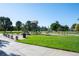 A playground is surrounded by a sunny green space complete with a mix of slides, swings and climbing structures at 5481 E 117Th Ave, Thornton, CO 80233