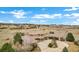 Aerial view of a large home with well-manicured lawns, mature trees, and a circular driveway at 5625 Twilight Way, Parker, CO 80134