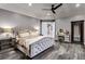 Cozy bedroom with elegant furnishings, including a tufted bed frame, mirrored nightstand and dark wood floors at 5625 Twilight Way, Parker, CO 80134