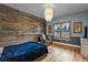 This cozy bedroom features a wood accent wall, hardwood floors, and a stylish chandelier at 5625 Twilight Way, Parker, CO 80134