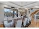 Elegant dining room with a large wooden table, upholstered chairs, and a modern chandelier at 5625 Twilight Way, Parker, CO 80134