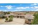 The exterior view showcases a large home with a circular driveway, desert landscape, and desert view at 5625 Twilight Way, Parker, CO 80134