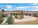 An exterior shot of a residence boasting a large circular driveway and desert landscaping at 5625 Twilight Way, Parker, CO 80134