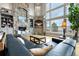 Cozy living room featuring a stone fireplace, built-in shelving, and panoramic views from large windows at 5625 Twilight Way, Parker, CO 80134