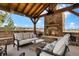 Covered outdoor seating area with stone fireplace, comfortable sofas, and scenic views at 5625 Twilight Way, Parker, CO 80134