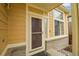 Front entrance with storm door and brick detailing at 2946 S Espana Ct, Aurora, CO 80013