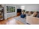 Sunlit living room showcasing hardwood floors, a cozy seating area and a large window at 640 Marble St, Broomfield, CO 80020