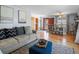 Cozy living room with hardwood floors, neutral sectional, and open layout to the entrance at 640 Marble St, Broomfield, CO 80020