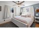 Bright main bedroom featuring a large bed, ceiling fan, and an abundance of natural light at 640 Marble St, Broomfield, CO 80020