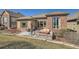 Charming backyard features patio seating, brick accents and manicured lawn at 12114 Alcott St, Westminster, CO 80234