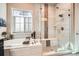 Modern bathroom with a soaking tub, a glass-enclosed shower, and updated fixtures at 12114 Alcott St, Westminster, CO 80234