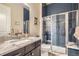 Beautiful bathroom featuring navy tiled walls and a frameless glass shower at 12114 Alcott St, Westminster, CO 80234