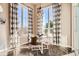 Charming dining area with a glass table, modern chairs, and decorative window treatments at 12114 Alcott St, Westminster, CO 80234