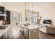 Bright open kitchen with granite countertops, dark cabinets, stainless appliances, and hardwood flooring at 12114 Alcott St, Westminster, CO 80234