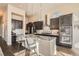 Modern kitchen with an island, dark cabinets, stainless appliances, and granite countertops at 12114 Alcott St, Westminster, CO 80234