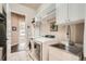 Convenient laundry room with modern appliances and ample shelving at 12114 Alcott St, Westminster, CO 80234
