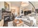 Open concept living space showcasing a fireplace and seamless flow to the kitchen at 12114 Alcott St, Westminster, CO 80234