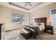 Comfortable main bedroom with a large window, ceiling fan, and stylish furnishings at 12114 Alcott St, Westminster, CO 80234