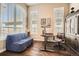 Bright home office featuring hardwood floors, a built-in cabinet, and multiple windows at 12114 Alcott St, Westminster, CO 80234