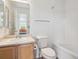 Updated bathroom with tub and shower combo, vanity, and toilet at 9697 Marmot Ridge Cir, Littleton, CO 80125