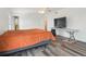 Spacious bedroom featuring a ceiling fan, large windows, and wood floors at 9697 Marmot Ridge Cir, Littleton, CO 80125